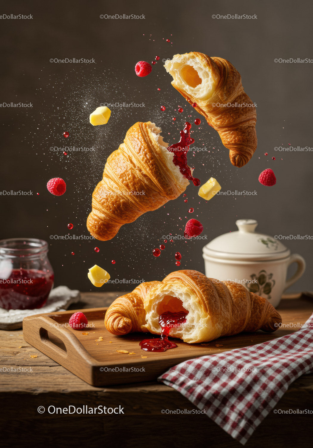 Fresh croissants with raspberry jam and butter cubes