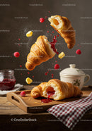 Fresh croissants with raspberry jam and butter cubes