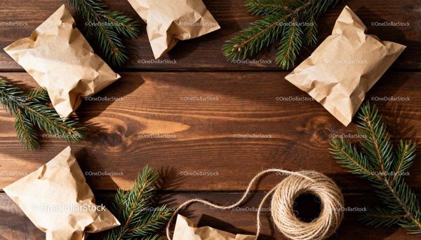 Natural Kraft Paper Packages with Pine Branches on Wood