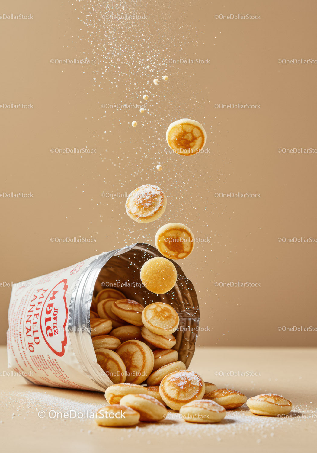 Mini Dutch Pancakes Pouring from Packaging with Powdered Sugar