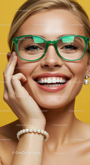Smiling woman in green glasses and pearl jewelry