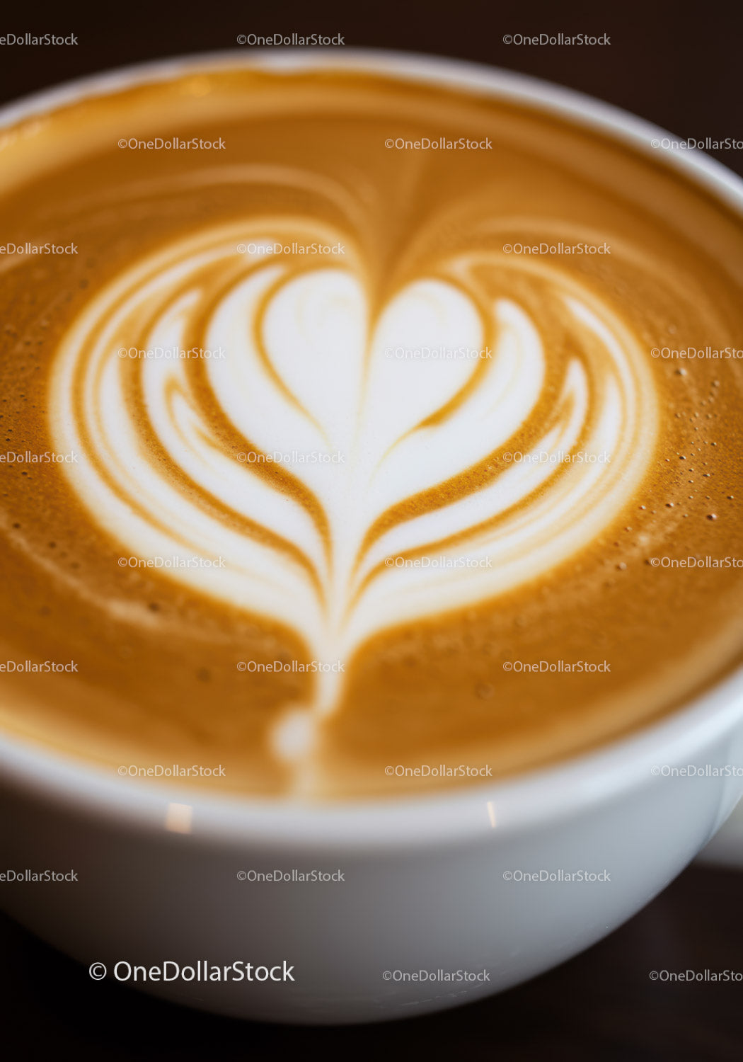 Heart shaped latte art in white cup of coffee