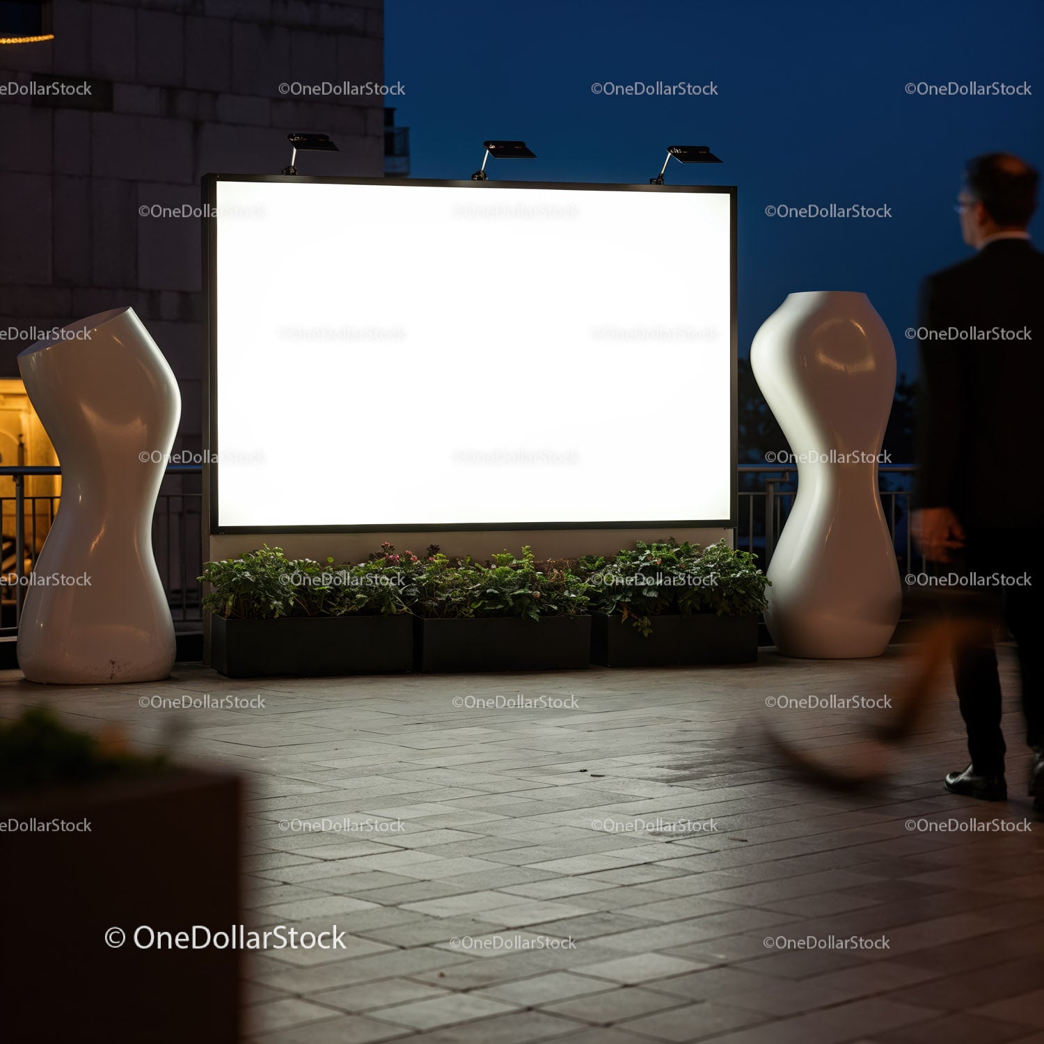 Nighttime urban scene with blank illuminated billboard