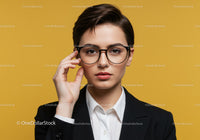 Professional Woman Wearing Glasses in Business Attire Against Yellow Background
