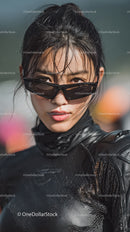 Confident Woman with Sunglasses in Stylish Black Outfit