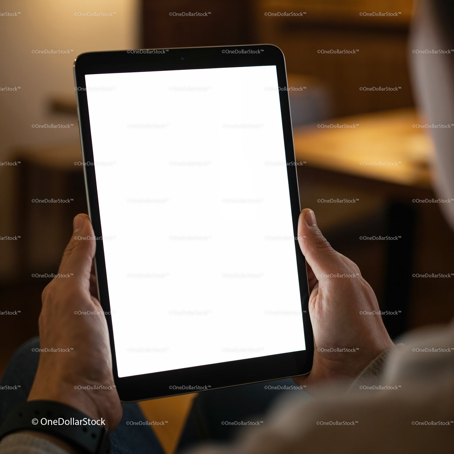 Hands holding digital tablet with blank white screen