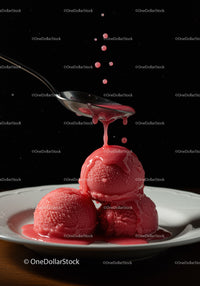 Red Sorbet Scoops with Dripping Syrup on Spoon