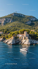 Mediterranean Coastal Landscape with Rocky Cliffs and Yacht