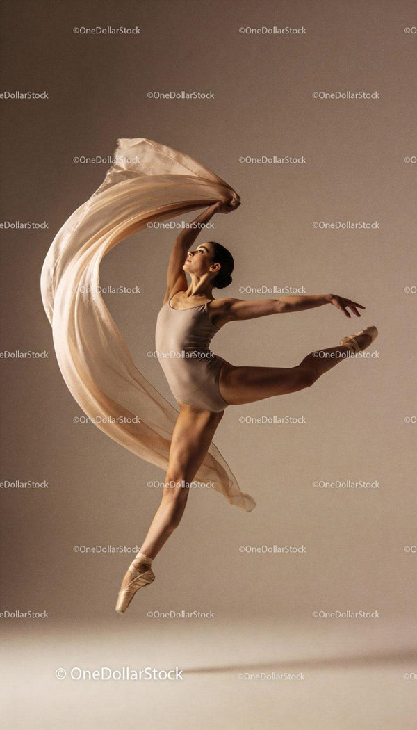 Graceful ballet dancer in mid-air with flowing scarf