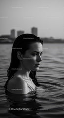 Serene Female Portrait in Water with Urban Background