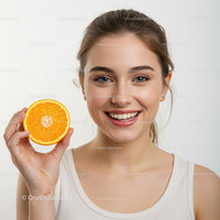 Happy Young Woman Holding Orange Slice for Fresh Summer Vibes