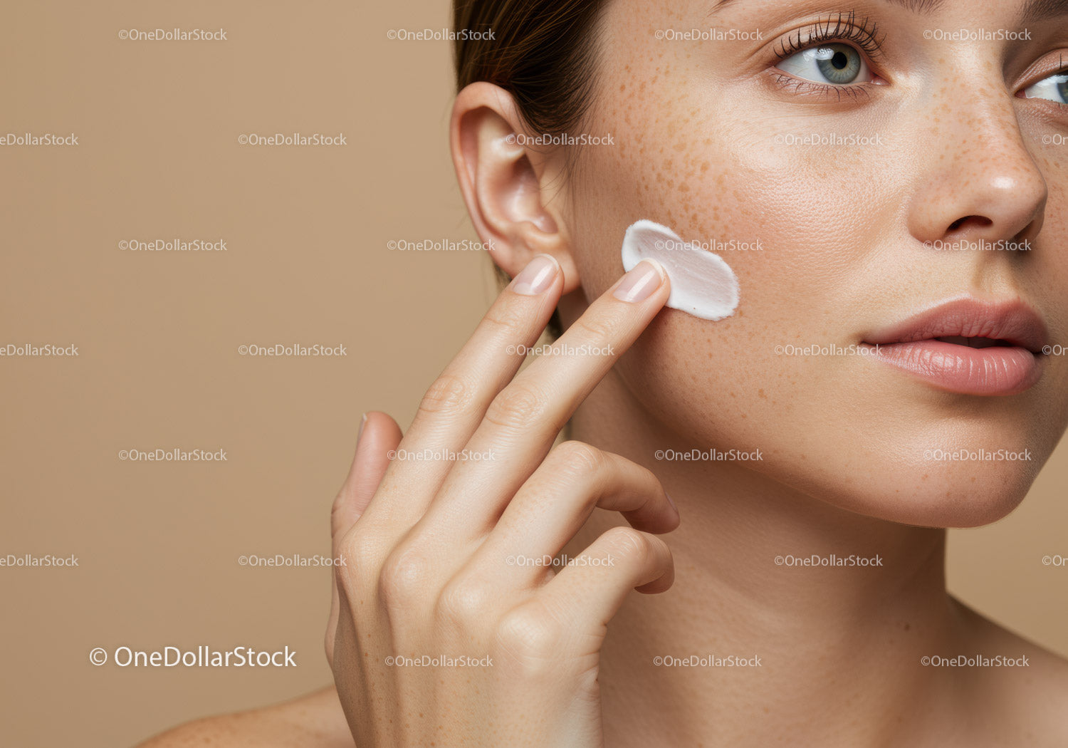 Close-up of Woman Applying Moisturizer to Cheek for Skincare Routine