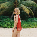 Stylish Woman in Swimwear with Red Tote on Tropical Beach