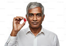 Middle-Aged Man Holding Raspberry for Healthy Lifestyle and Nutrition