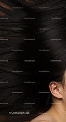 Closeup of woman ear with flowing dark hair spread out