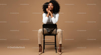 Stylish Confident Woman Sitting on Chair in Modern Studio