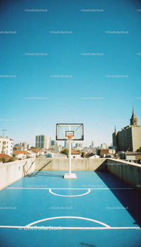 Rooftop Basketball Court Under Clear Blue Sky with City Skyline