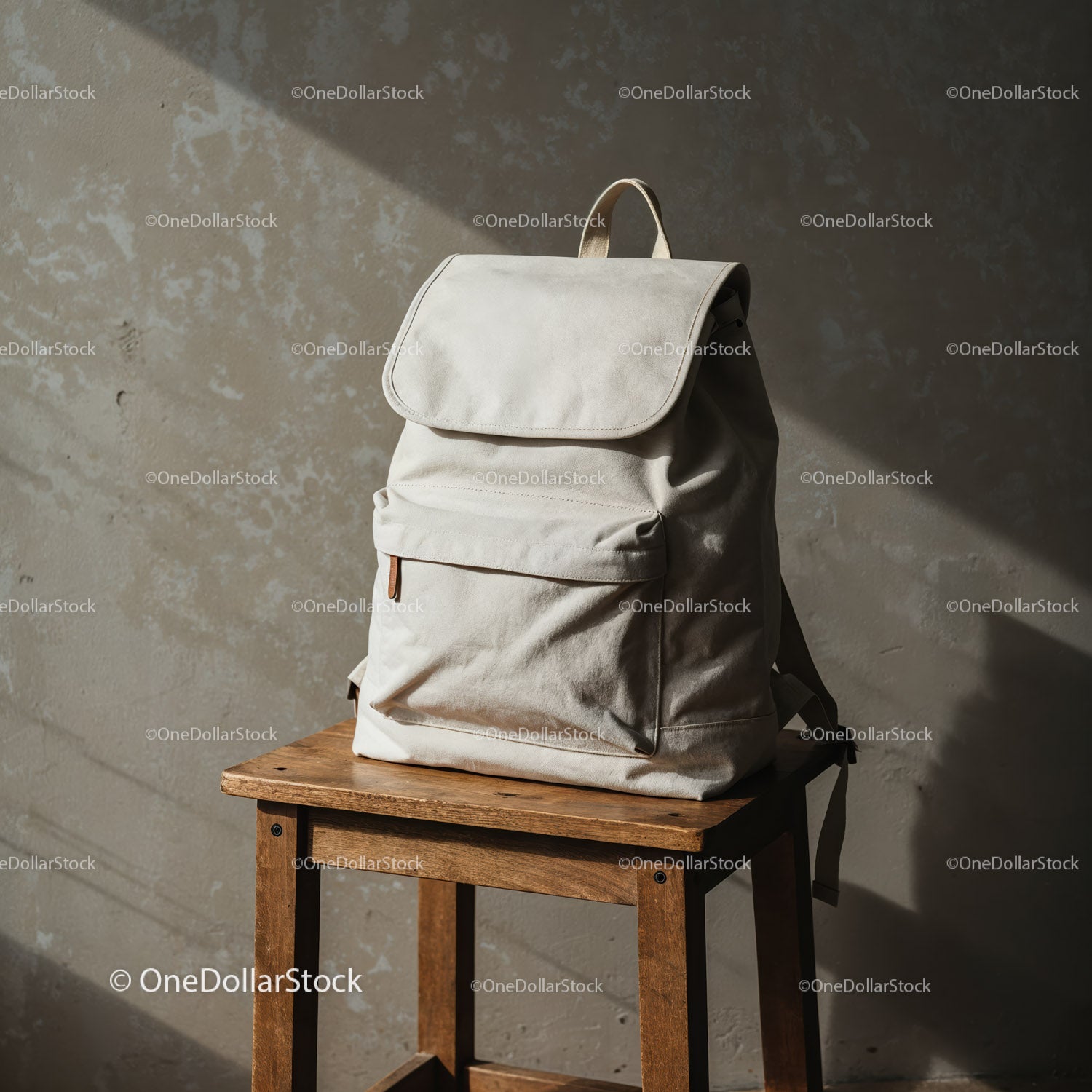 Minimalist light beige backpack on rustic wooden stool