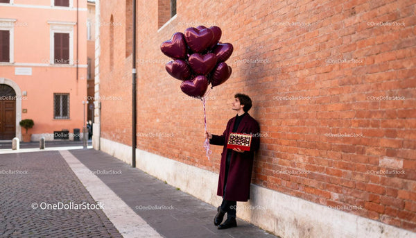 Man Holding Heart Balloons and Chocolate Box Outdoors