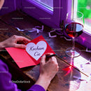 Writing a Romantic Card with Red Wine by the Window