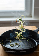 Sautéing Onions with Fresh Rosemary in Cast Iron Pan