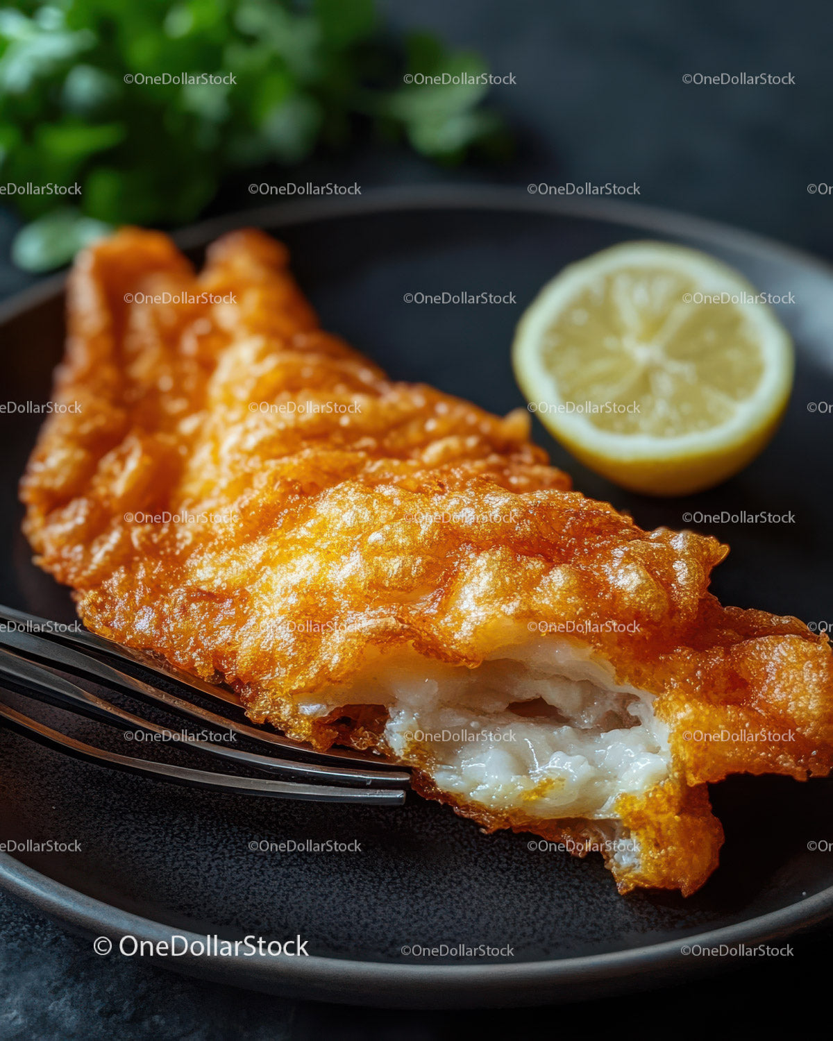 Crispy Fried Fish Fillet with Lemon Wedge and Herbs