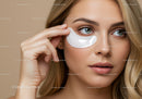 Young Woman Applying Under Eye Patch for Skin Rejuvenation