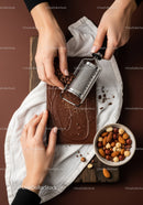 Chocolate Bar with Nut Toppings Being Grated for Dessert
