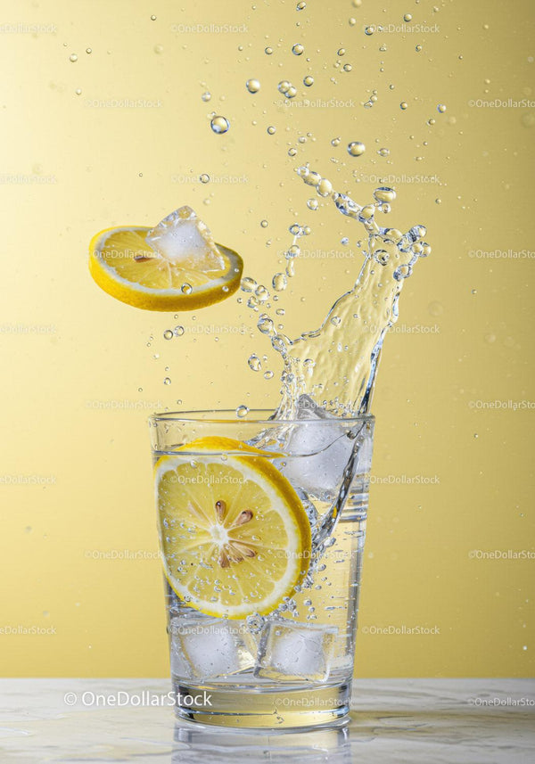 Refreshing Lemon Slice Splashing into Clear Water Glass