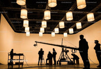 Film Crew Working on Set with Suspended Lantern Lights