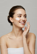 Young Woman Applying Face Cream for Healthy Glowing Skin