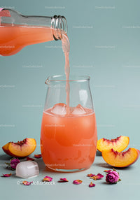 Refreshing peach juice poured over ice in clear glass