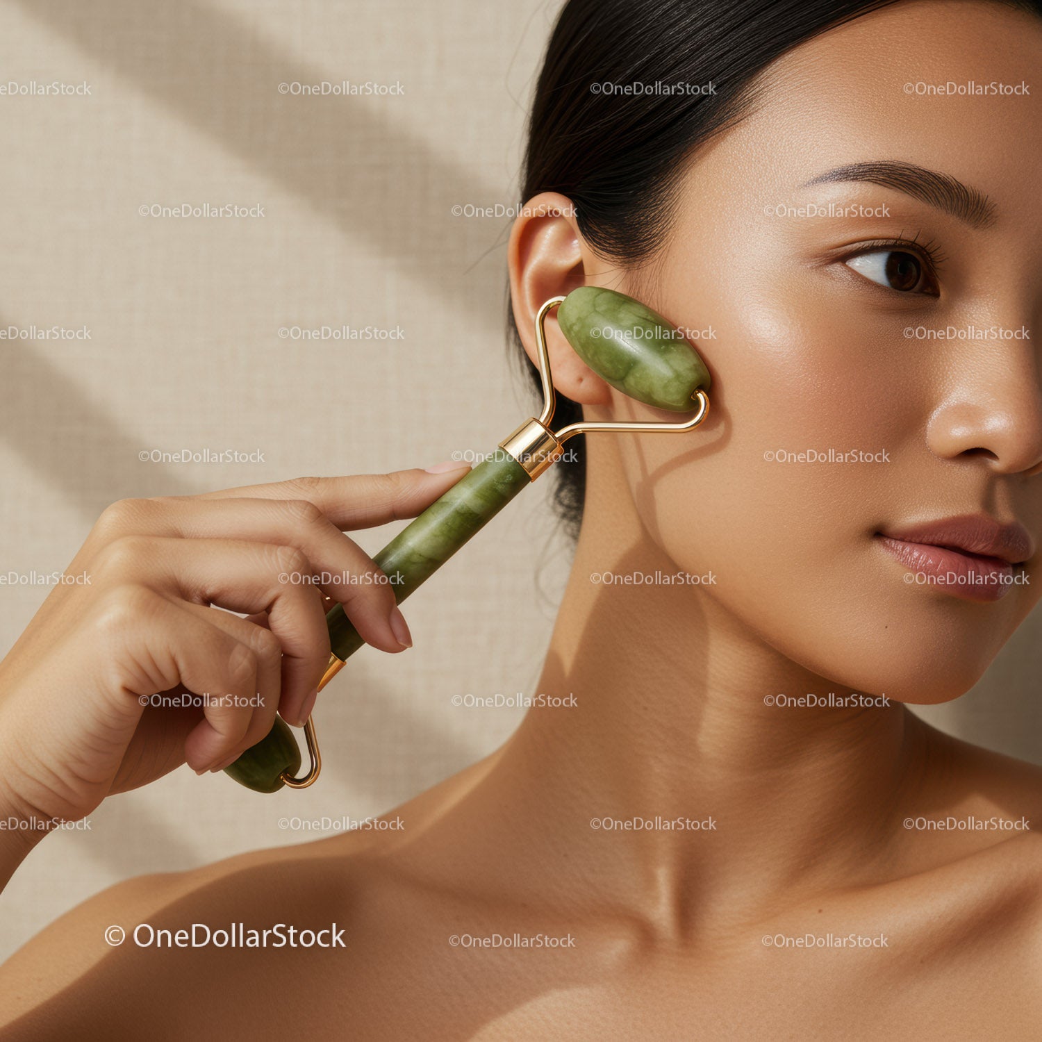 Woman Using Jade Roller for Skin Care and Facial Massage