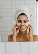 Smiling young woman with face mask and eye patches