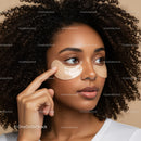 Woman with Curly Hair Applying Eye Patches for Skincare Routine