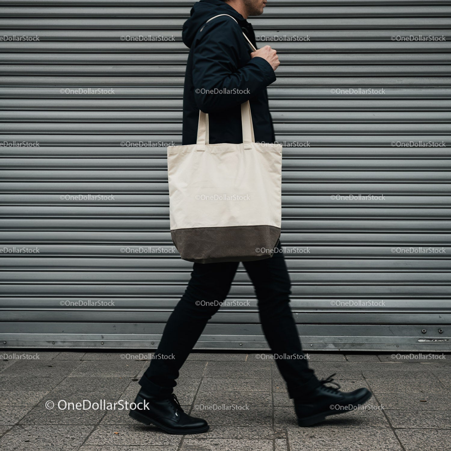 Man walking with canvas tote bag on city street