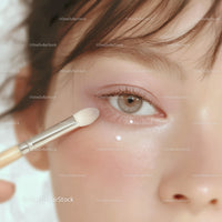 Close-Up of Eye Makeup Application with Brush on Natural Skin