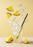 Refreshing Pineapple Coconut Drink with Ice Cubes Splash