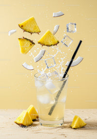 Refreshing Pineapple Coconut Drink with Ice Cubes Splash