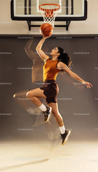Athletic Woman Jumping for Basketball Layup Shot