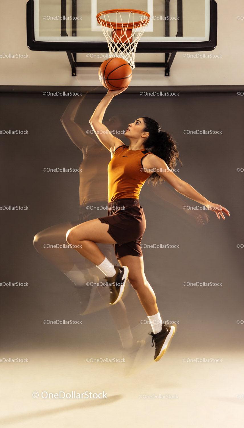 Athletic Woman Jumping for Basketball Layup Shot