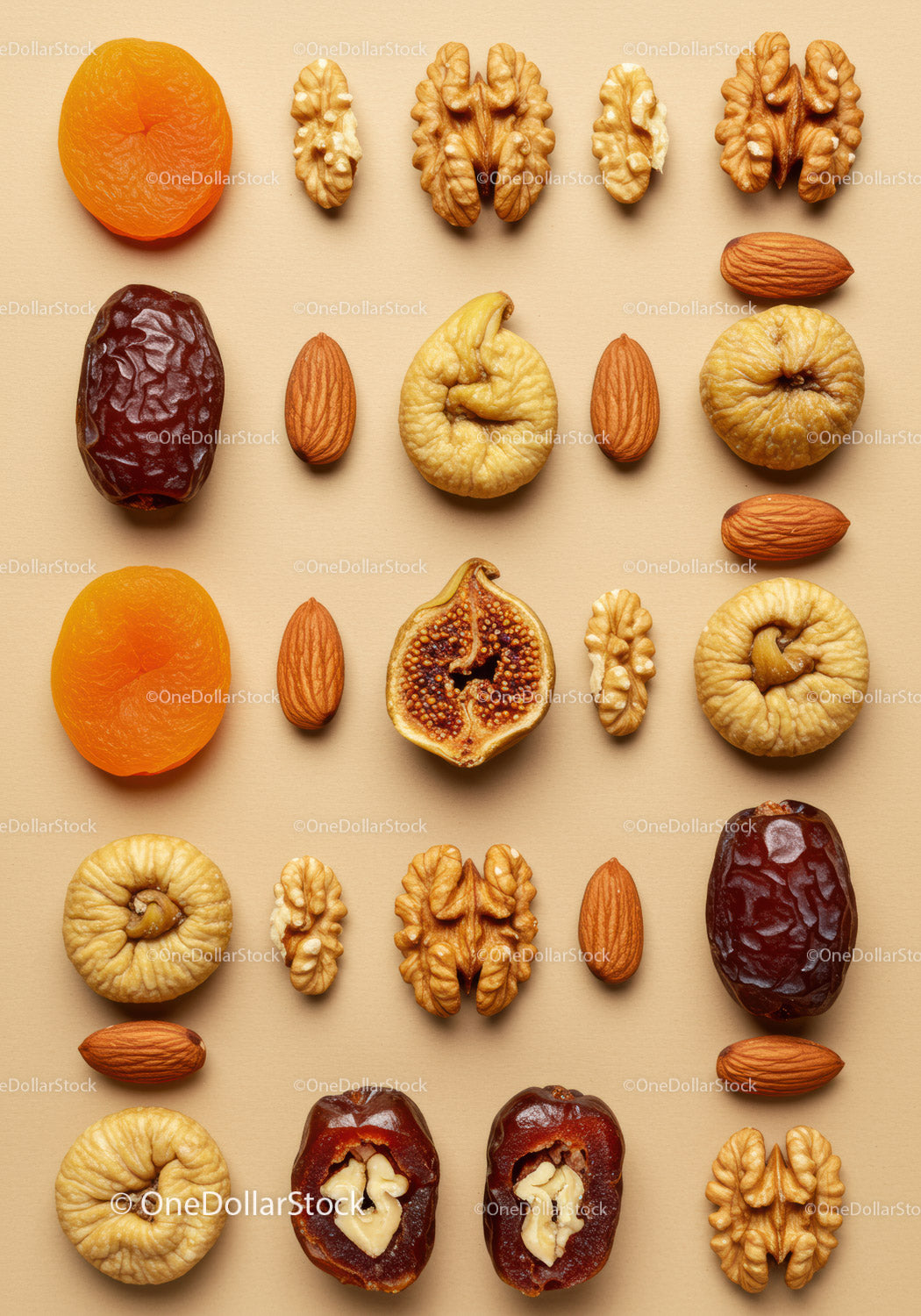 Assorted dried fruits and nuts arranged on beige background