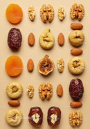 Assorted dried fruits and nuts arranged on beige background