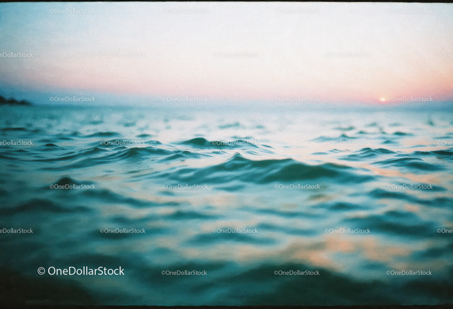 Serene Ocean Scene with Pink and Blue Sky at Sunset
