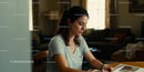 Thoughtful woman writing at home in relaxed atmosphere