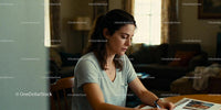 Thoughtful woman writing at home in relaxed atmosphere