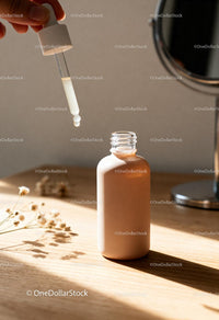 Natural skincare serum dropper with beige bottle on wood