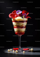 Elegant layered dessert with fresh berries and edible flowers