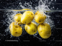 Yellow Passion Fruits Splashing into Water in Vibrant Food Scene