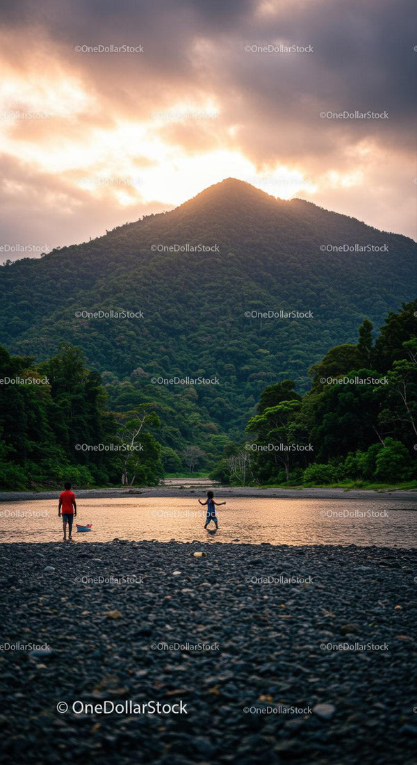 Scenic Mountain Landscape with Children Playing by River During Sunset